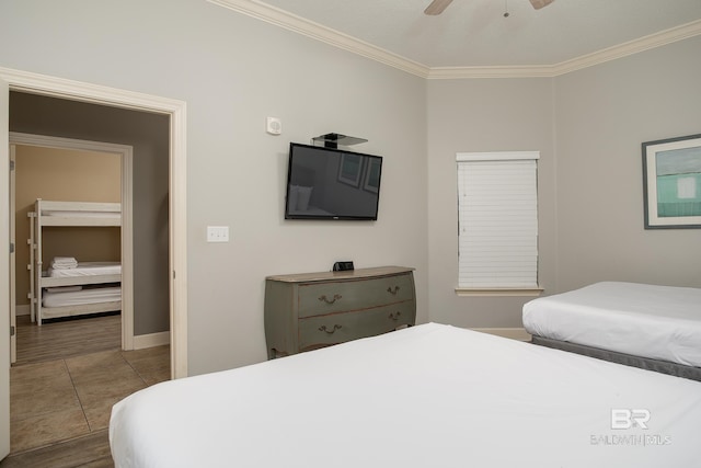 bedroom with tile patterned flooring, baseboards, crown molding, and ceiling fan