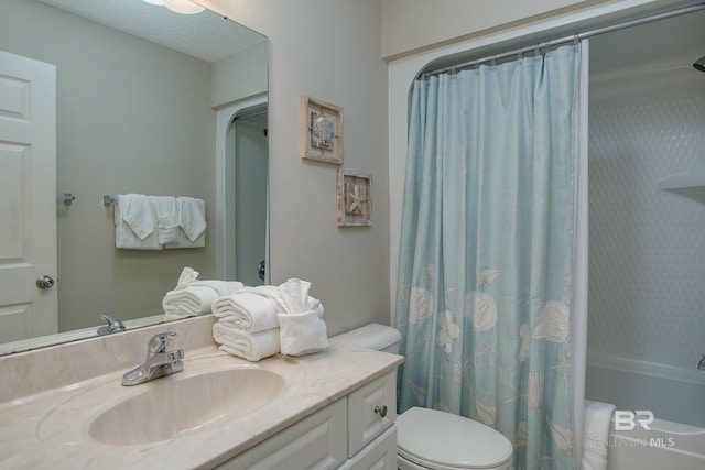 bathroom featuring vanity, toilet, and a textured ceiling