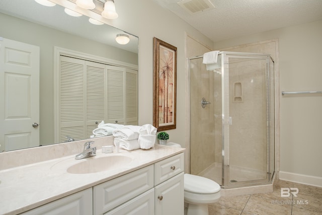 bathroom with visible vents, vanity, a shower stall, and a textured ceiling