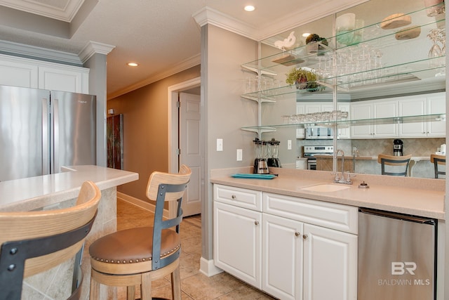 bar with decorative backsplash, stainless steel appliances, crown molding, and a sink