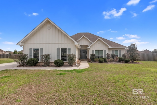 view of front of property with a front lawn, board and batten siding, and fence