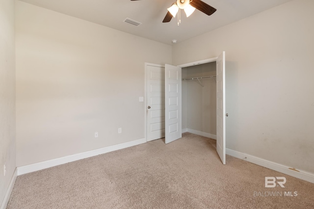 unfurnished bedroom with visible vents, baseboards, a ceiling fan, light colored carpet, and a closet