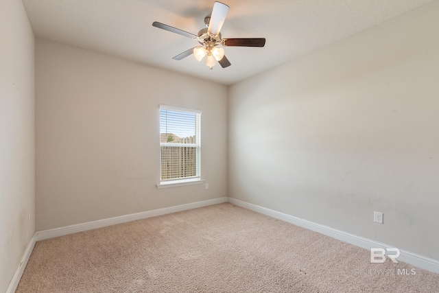 unfurnished room with light carpet, ceiling fan, and baseboards