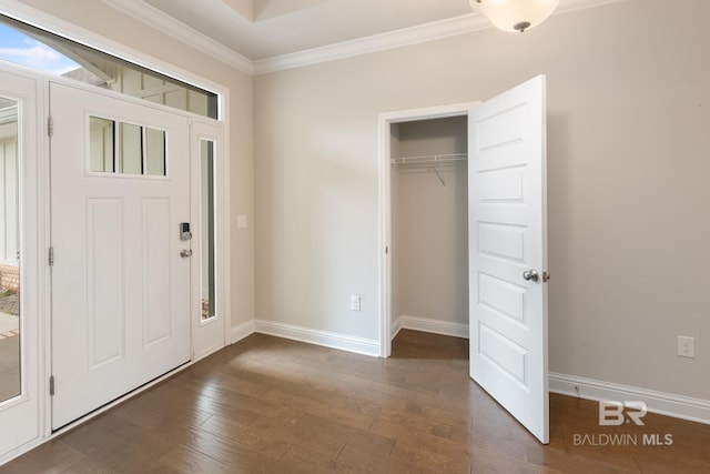 entryway featuring ornamental molding, dark wood-type flooring, and baseboards