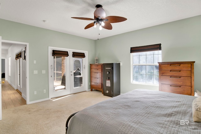 bedroom with ceiling fan, french doors, light hardwood / wood-style flooring, a textured ceiling, and access to outside