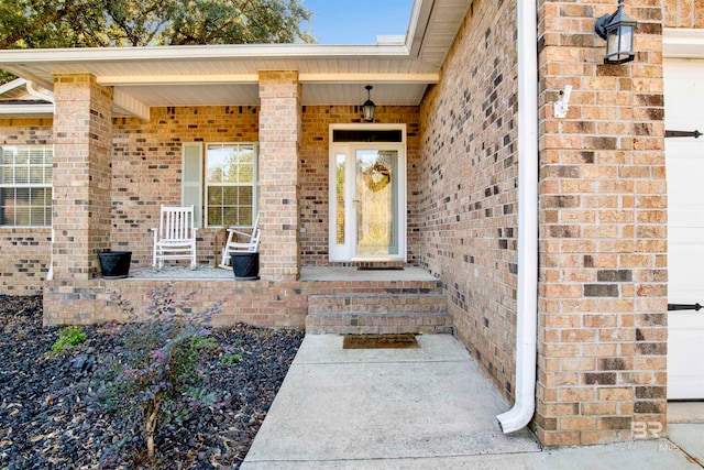 view of exterior entry with covered porch