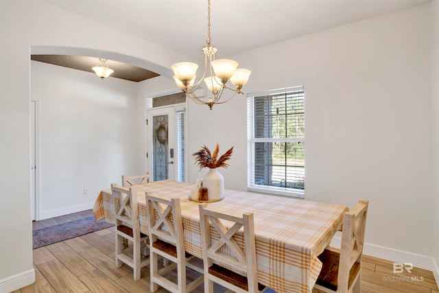 dining area with a chandelier and light wood-type flooring