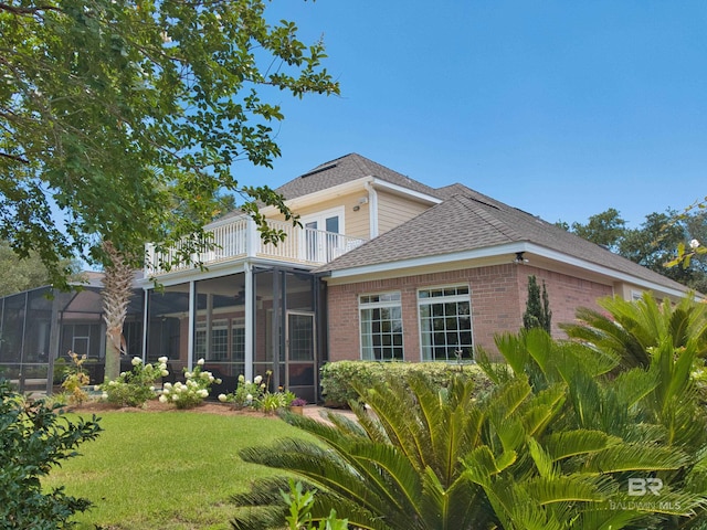 305 Peninsula Blvd, Gulf Shores, AL 36542 - rear view of house with a balcony and a lawn