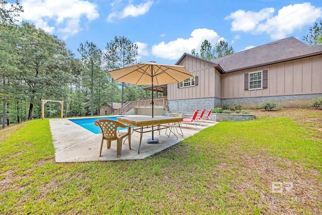 view of yard featuring a pool side deck and a patio