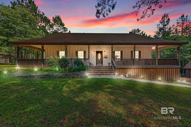 view of front of property featuring a yard and covered porch