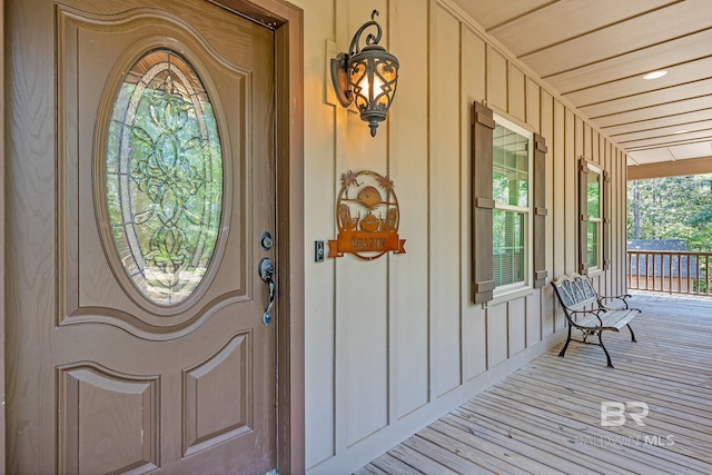 view of exterior entry with a porch