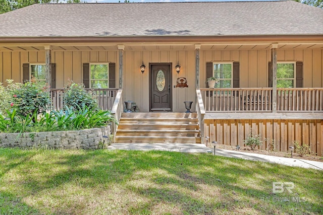 property entrance featuring covered porch and a yard