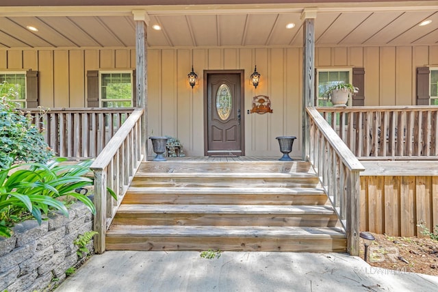 view of exterior entry featuring covered porch