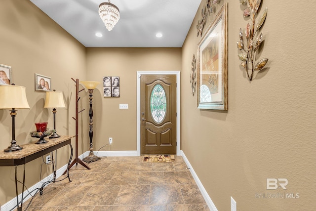 foyer with a chandelier