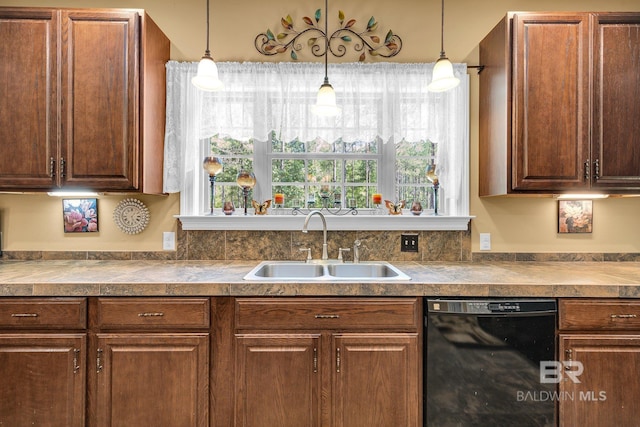 kitchen featuring decorative light fixtures, dishwasher, and sink