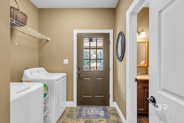 laundry room featuring sink and washer and clothes dryer