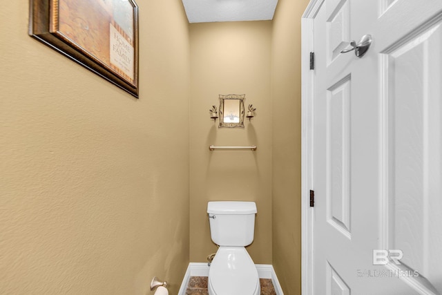 bathroom with toilet and tile patterned floors