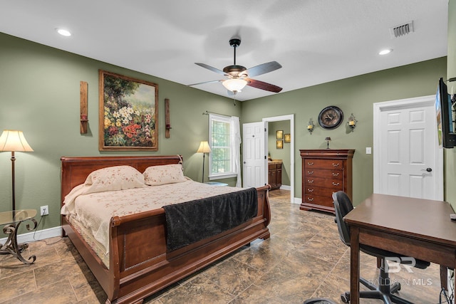 bedroom featuring ceiling fan and ensuite bath