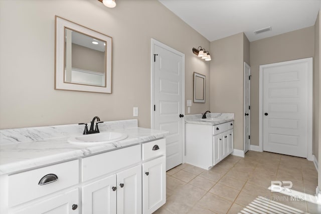 bathroom with tile patterned flooring and vanity