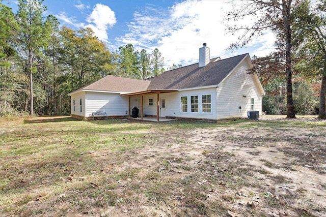 back of property with a yard, a patio, and cooling unit