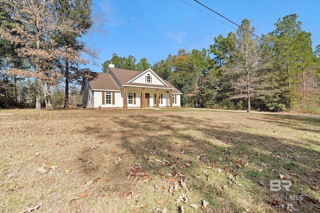 view of front of home with covered porch and a front yard