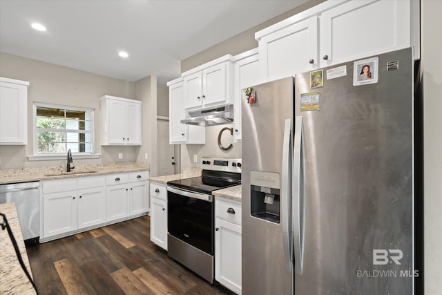 kitchen with white cabinets, light stone countertops, sink, and appliances with stainless steel finishes