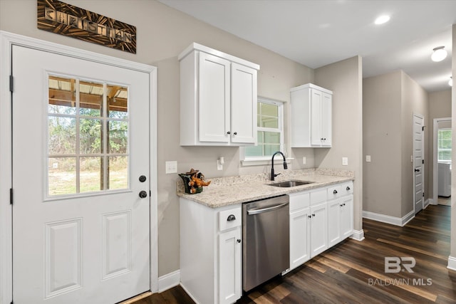 kitchen featuring light stone countertops, dishwasher, sink, dark hardwood / wood-style floors, and white cabinets