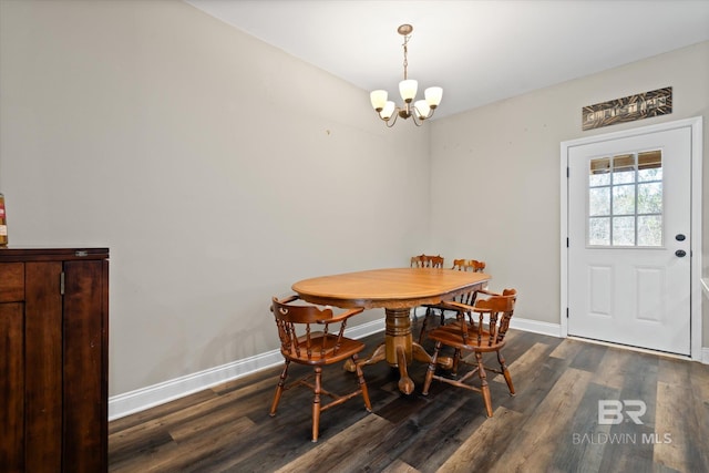 dining room with dark wood-type flooring and a chandelier