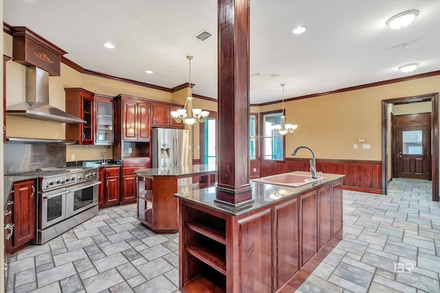 kitchen featuring a kitchen island with sink, a sink, visible vents, appliances with stainless steel finishes, and glass insert cabinets