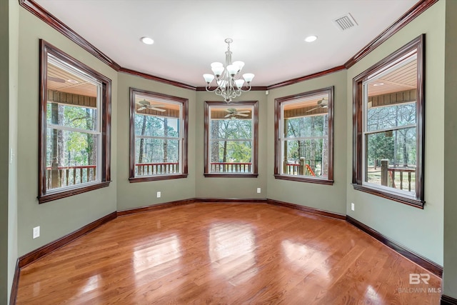 unfurnished room with ornamental molding, baseboards, visible vents, and light wood finished floors