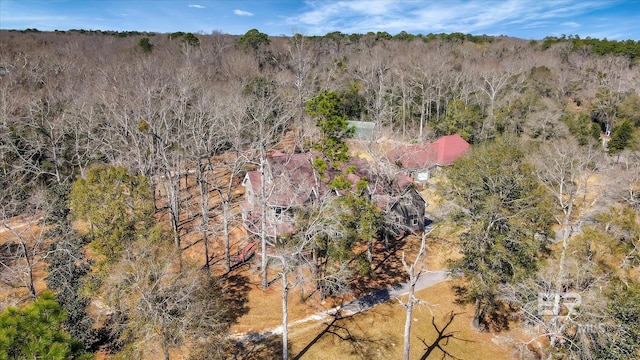 birds eye view of property with a view of trees