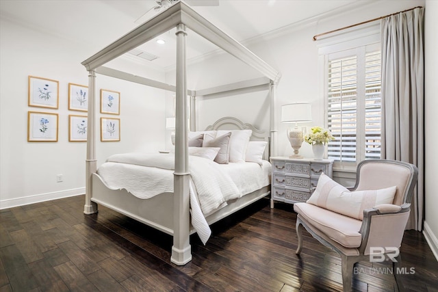 bedroom with dark hardwood / wood-style flooring and crown molding