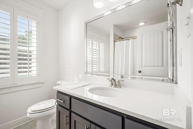 bathroom featuring walk in shower, vanity, and toilet