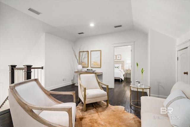 living area with dark hardwood / wood-style flooring and lofted ceiling