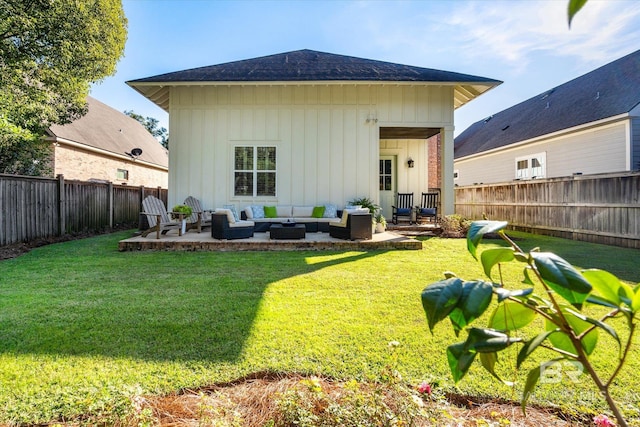 back of house with outdoor lounge area, a yard, and a patio