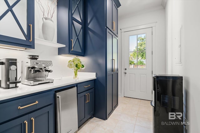 interior space featuring beverage cooler, blue cabinets, and light tile patterned floors