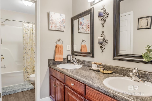 full bathroom with vanity, hardwood / wood-style floors, toilet, and shower / bath combo