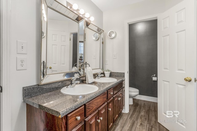 bathroom with vanity, hardwood / wood-style flooring, and toilet