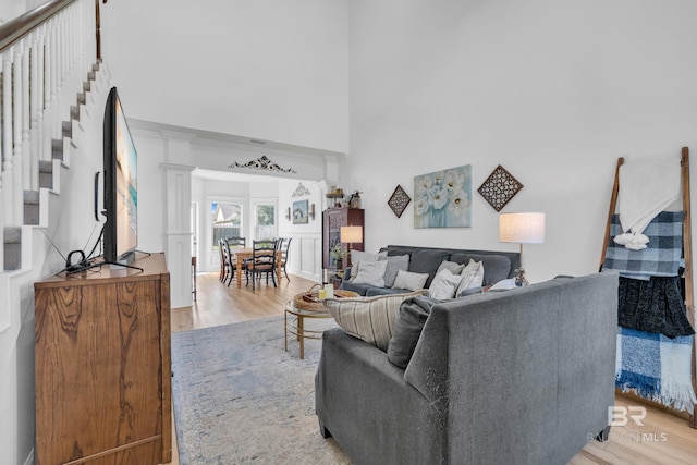 8847 Asphodel Ln, Daphne, AL 36526 - living room with light wood finished floors, stairs, and a high ceiling