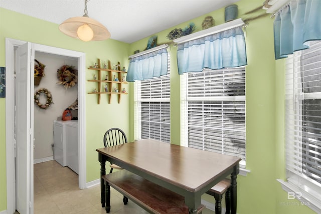 dining room with baseboards, light tile patterned flooring, and washer and clothes dryer