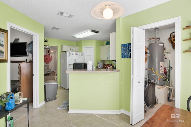 kitchen with visible vents, a textured ceiling, white refrigerator with ice dispenser, gas water heater, and light countertops