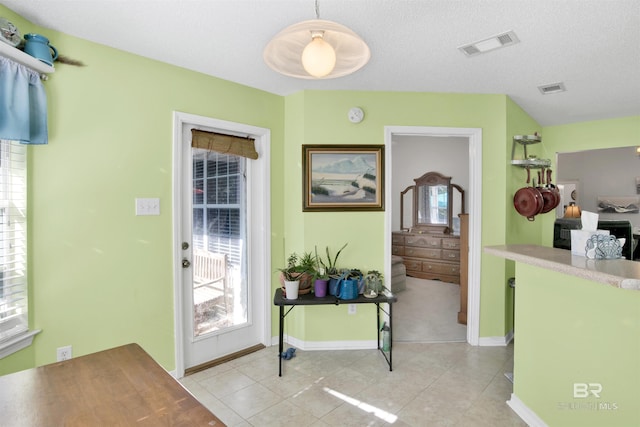 entrance foyer with visible vents, baseboards, a textured ceiling, and light tile patterned flooring