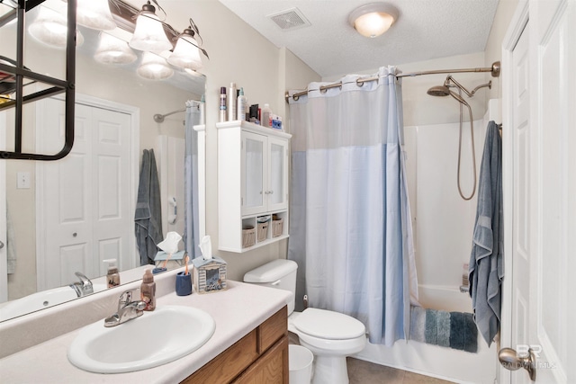 full bathroom featuring vanity, shower / bath combination with curtain, a textured ceiling, tile patterned floors, and toilet