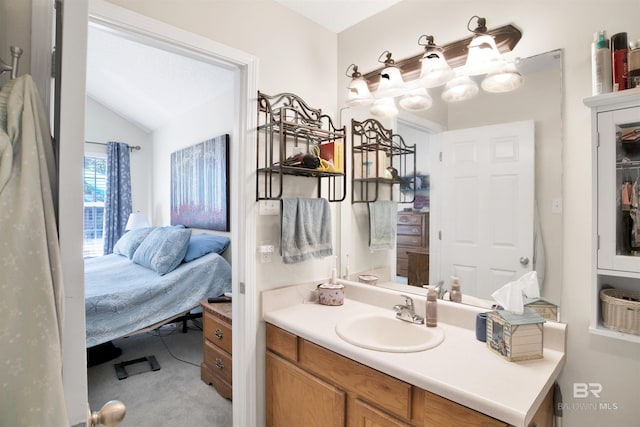 ensuite bathroom with vanity, ensuite bathroom, and lofted ceiling