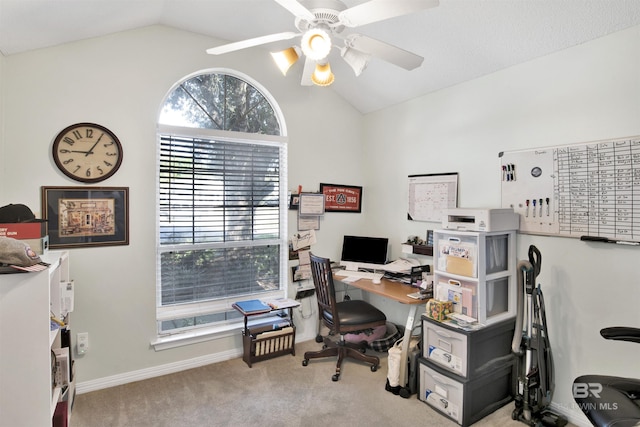 office space featuring a ceiling fan, lofted ceiling, carpet, and baseboards