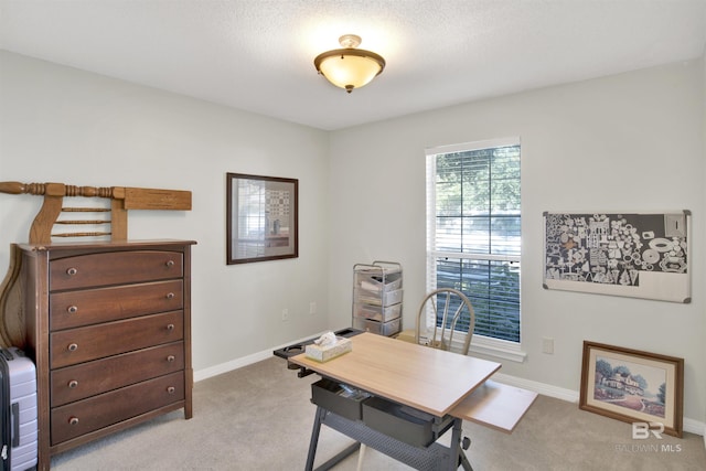 carpeted office space with baseboards