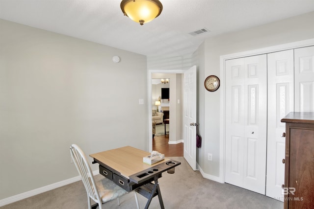 office area with light carpet, visible vents, and baseboards