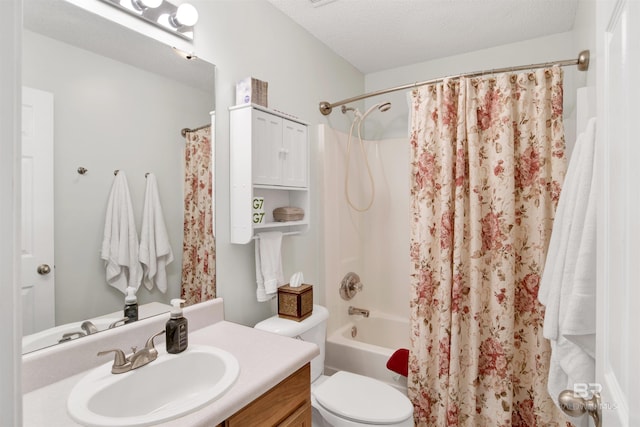 full bath with vanity, toilet, shower / bath combo, and a textured ceiling