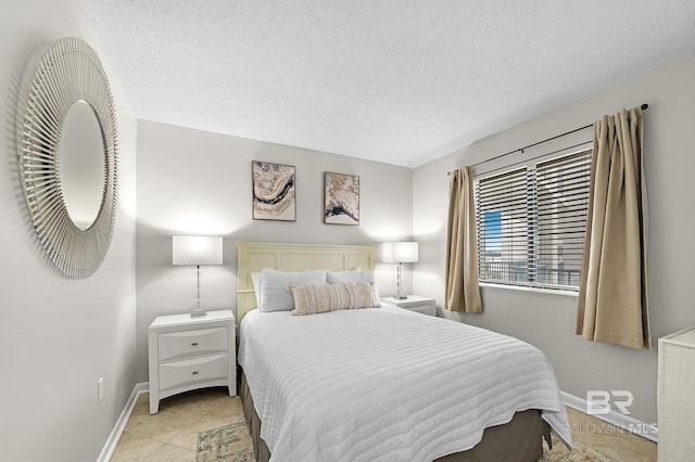 bedroom featuring a textured ceiling and light tile patterned floors