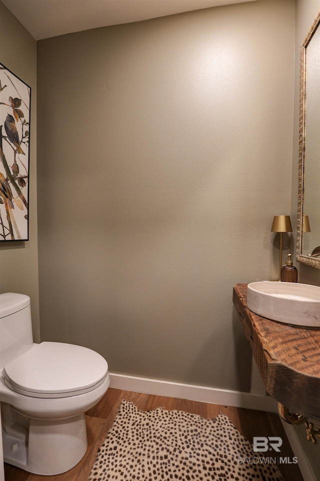 bathroom featuring toilet and hardwood / wood-style flooring